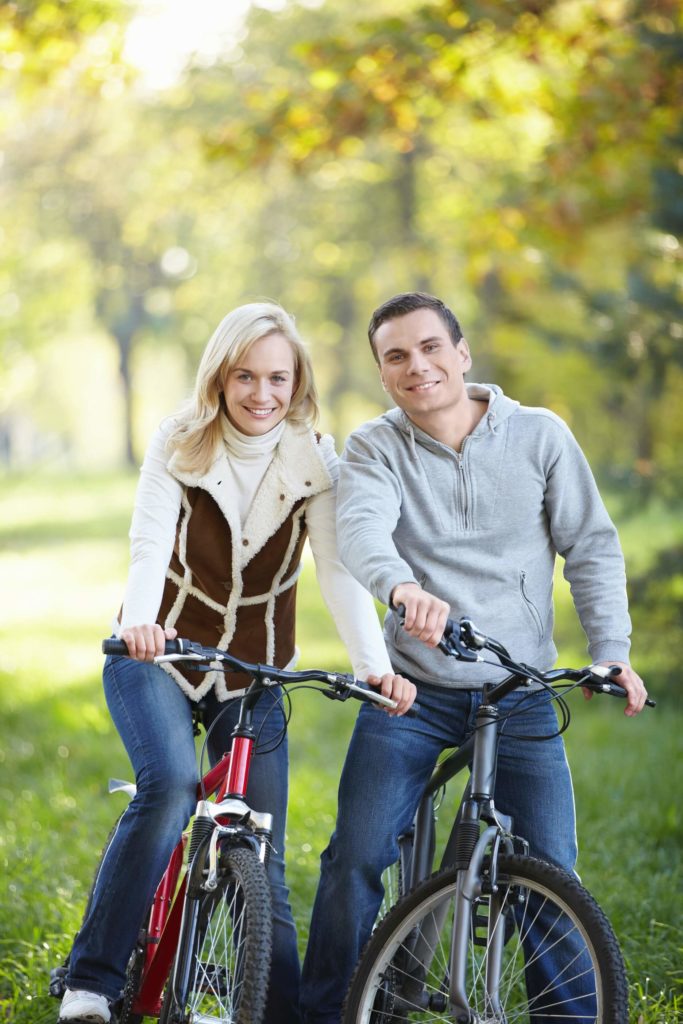 couple on bikes smiling