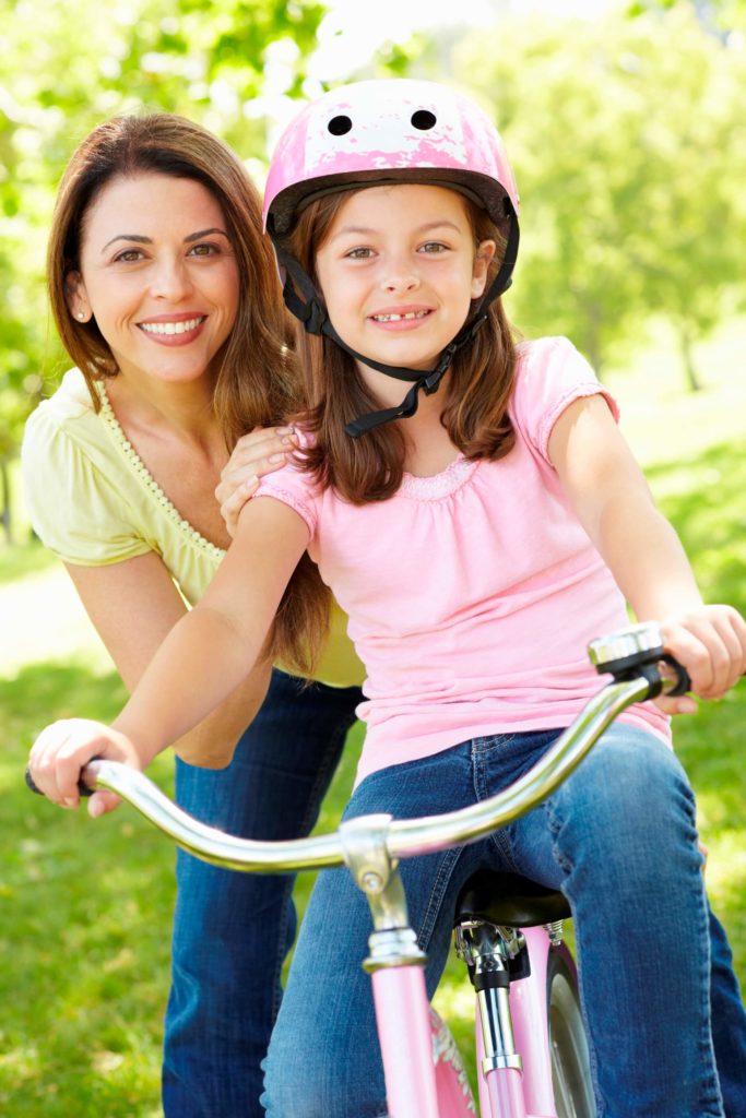 mom with daughter riding bike
