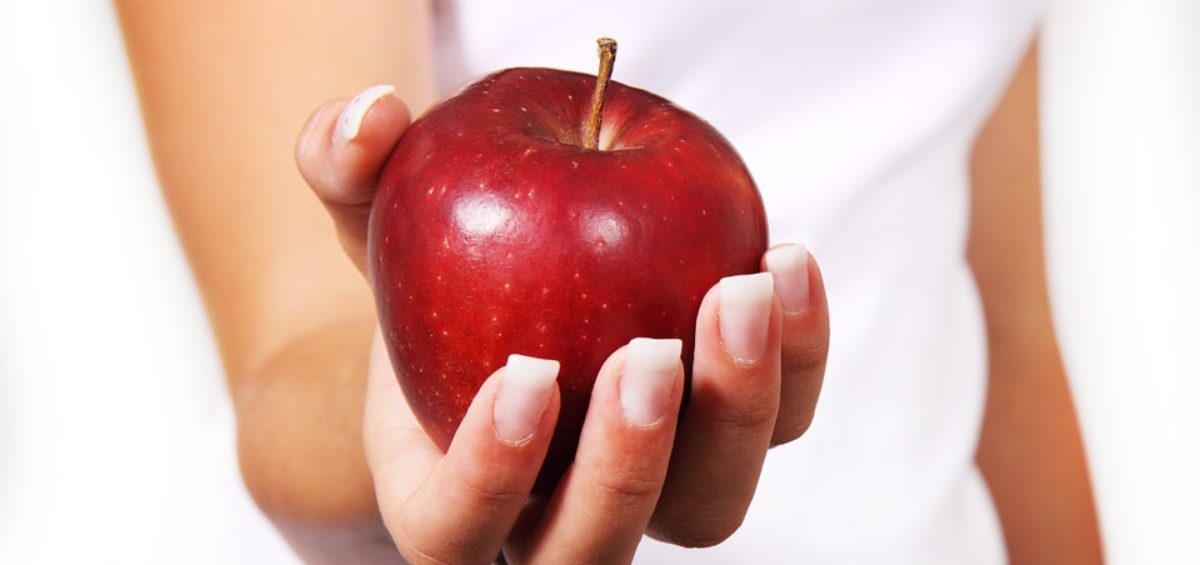 Apple in woman's hand.